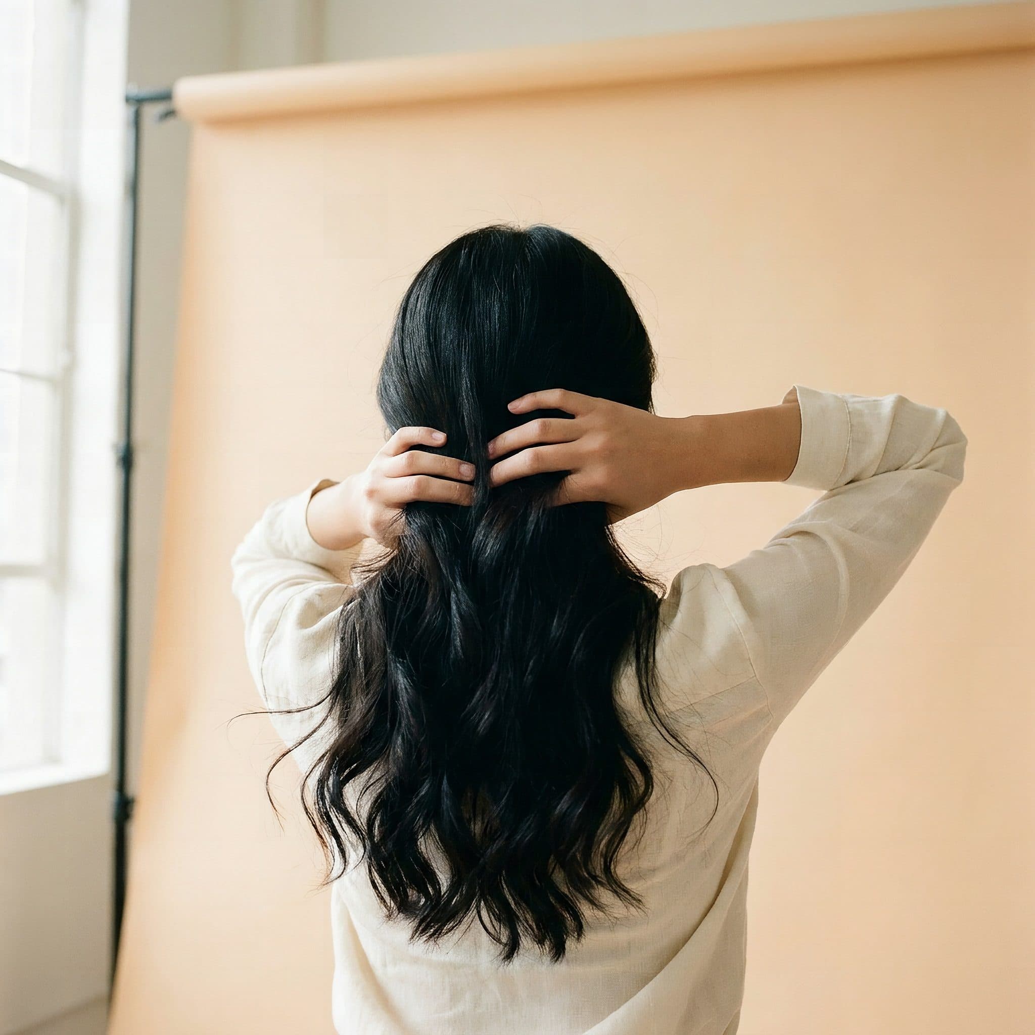 Long dark hair with a soft, nourished shine after the oiling ritual